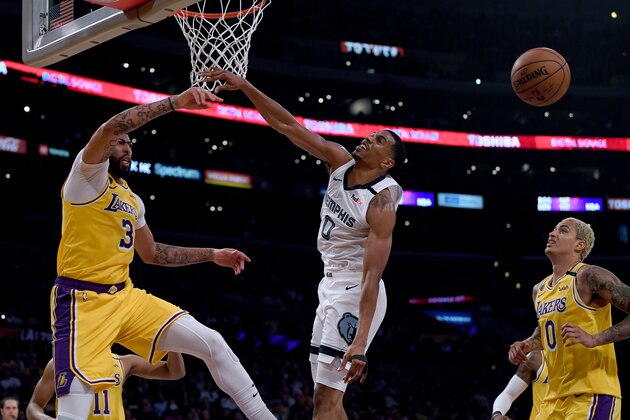 LOS ANGELES, CALIFORNIA - FEBRUARY 21:  Anthony Davis #3 of the Los Angeles Lakers blocks De'Anthony Melton #0 of the Memphis Grizzlies as Kyle Kuzma #0 looks on during the third quarter at Staples Center on February 21, 2020 in Los Angeles, California.  NOTE TO USER: User expressly acknowledges and agrees that, by downloading and or using this photograph, User is consenting to the terms and conditions of the Getty Images License Agreement. (Photo by Harry How/Getty Images)