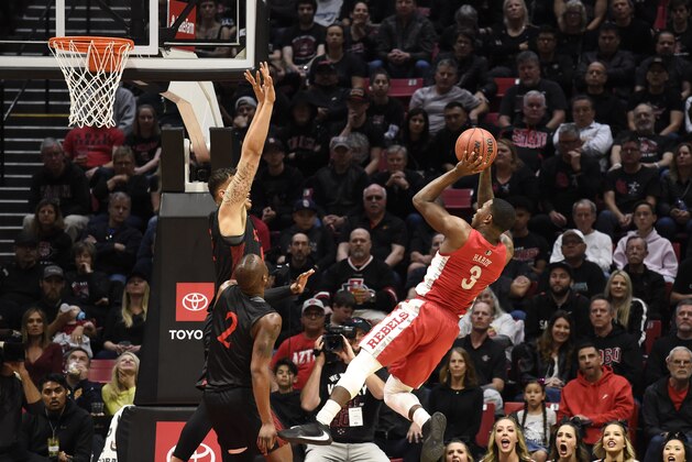 UNLV guard Amauri Hardy (3) shoots over San Diego State forward Nolan Narain (12) during the first half of an NCAA college basketball game Saturday, Feb. 22, 2020, in San Diego. (AP Photo/Denis Poroy)