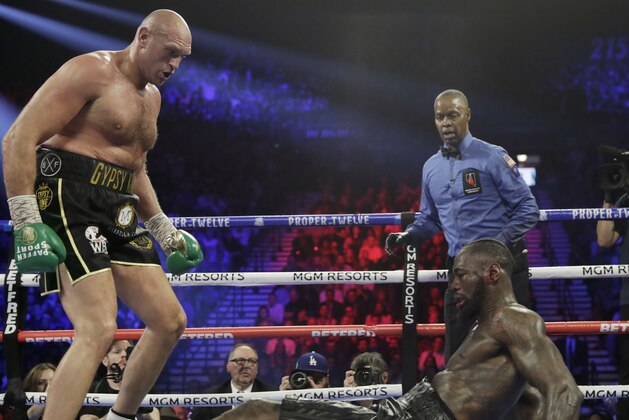 Tyson Fury, of England, knocks down Deontay Wilder during a WBC heavyweight championship boxing match Saturday, Feb. 22, 2020, in Las Vegas. (AP Photo/Isaac Brekken)