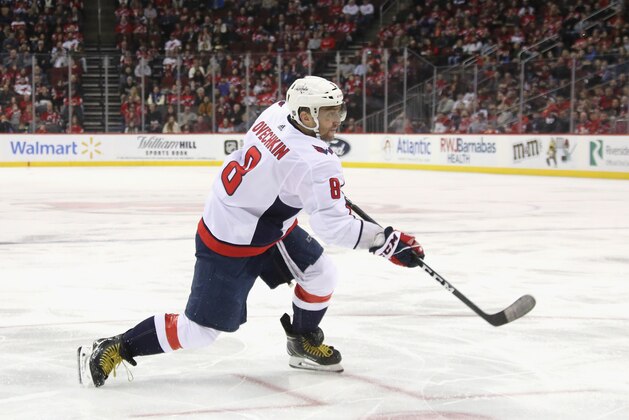 NEWARK, NEW JERSEY - FEBRUARY 22: Alex Ovechkin #8 of the Washington Capitals scores at 4:50 of the third period against the New Jersey Devils at the Prudential Center on February 22, 2020 in Newark, New Jersey. With the goal, Ovechkin became the eight player in NHL history to score 700 goals. (Photo by Bruce Bennett/Getty Images)