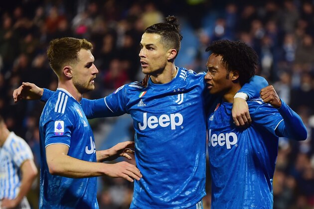 FERRARA, ITALY - FEBRUARY 22:  Cristiano Ronaldo (L) of Juventus celebrates after scoring his first goal with teammates during the Serie A match between SPAL and  Juventus at Stadio Paolo Mazza on February 22, 2020 in Ferrara, Italy.  (Photo by Pier Marco Tacca/Getty Images)