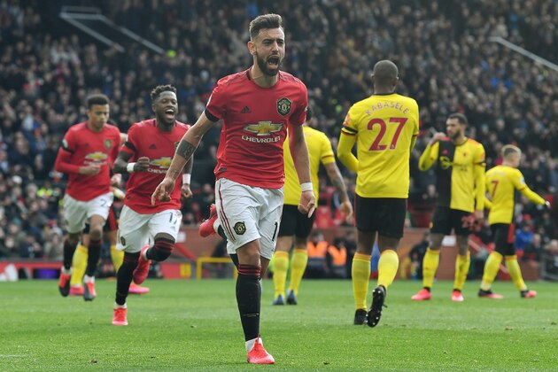 Manchester United's Portuguese midfielder Bruno Fernandes (C) celebrates scoring the opening goal from the penalty spot during the English Premier League football match between Manchester United and Watford at Old Trafford in Manchester, north west England, on February 23, 2020. (Photo by Paul ELLIS / AFP) / RESTRICTED TO EDITORIAL USE. No use with unauthorized audio, video, data, fixture lists, club/league logos or 'live' services. Online in-match use limited to 120 images. An additional 40 images may be used in extra time. No video emulation. Social media in-match use limited to 120 images. An additional 40 images may be used in extra time. No use in betting publications, games or single club/league/player publications. /  (Photo by PAUL ELLIS/AFP via Getty Images)