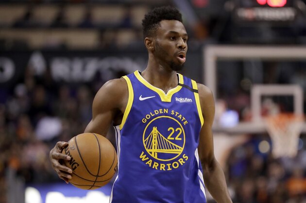 Golden State Warriors guard Andrew Wiggins (22) looks to pass against the Phoenix Suns during the second half of an NBA basketball game, Wednesday, Feb. 12, 2020, in Phoenix. (AP Photo/Matt York)