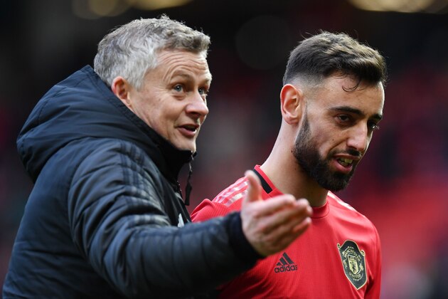 Manchester United's Portuguese midfielder Bruno Fernandes (R) and Manchester United's Norwegian manager Ole Gunnar Solskjaer (L) react as they leaves the pitch at the end of the English Premier League football match between Manchester United and Watford at Old Trafford in Manchester, north west England, on February 23, 2020. (Photo by Paul ELLIS / AFP) / RESTRICTED TO EDITORIAL USE. No use with unauthorized audio, video, data, fixture lists, club/league logos or 'live' services. Online in-match use limited to 120 images. An additional 40 images may be used in extra time. No video emulation. Social media in-match use limited to 120 images. An additional 40 images may be used in extra time. No use in betting publications, games or single club/league/player publications. /  (Photo by PAUL ELLIS/AFP via Getty Images)