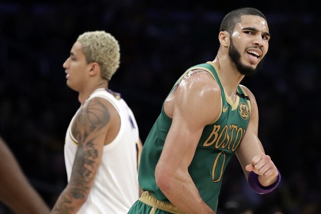 Boston Celtics' Jayson Tatum celebrates after a dunk by Jaylen Brown during the first half of an NBA basketball game against the Los Angeles Lakers Sunday, Feb. 23, 2020, in Los Angeles. (AP Photo/Marcio Jose Sanchez)