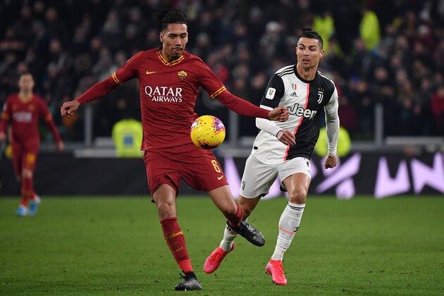 AS Roma's English defender Chris Smalling (L) and Juventus' Portuguese forward Cristiano Ronaldo go for the ball during the Italian Cup (Coppa Italia) round of 8 football match Juventus vs AS Roma on January 22, 2020 at the Juventus stadium in Turin. (Photo by Marco Bertorello / AFP) (Photo by MARCO BERTORELLO/AFP via Getty Images) AS Roma's English defender Chris Smalling (L) and Juventus' Portuguese forward Cristiano Ronaldo go for the ball during the Italian Cup (Coppa Italia) round of 8 football match Juventus vs AS Roma on January 22, 2020 at the Juventus stadium in Turin. (Photo by Marco Bertorello / AFP) (Photo by MARCO BERTORELLO/AFP via Getty Images)
