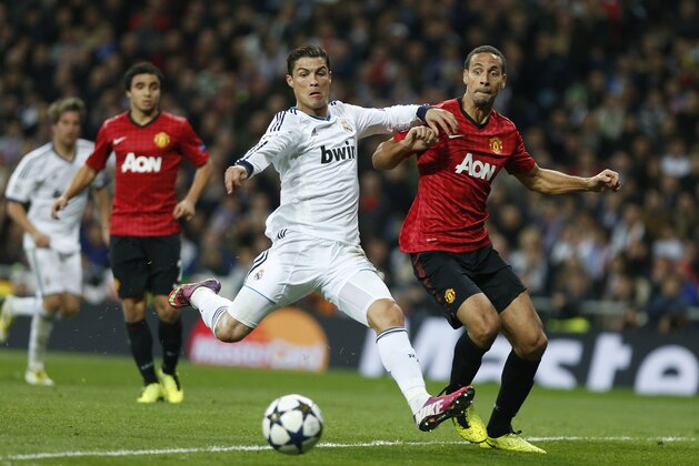 Manchester United's Rio Ferdinand, right, challenges Real Madrid's Cristiano Ronaldo from Portugal during the Champions League round of 16 first leg soccer match between Real Madrid and Manchester United at the Santiago Bernabeu stadium in Madrid, Wednesday Feb. 13, 2013. (AP Photo/Andres Kudacki) Manchester United's Rio Ferdinand, right, challenges Real Madrid's Cristiano Ronaldo from Portugal during the Champions League round of 16 first leg soccer match between Real Madrid and Manchester United at the Santiago Bernabeu stadium in Madrid, Wednesday Feb. 13, 2013. (AP Photo/Andres Kudacki)