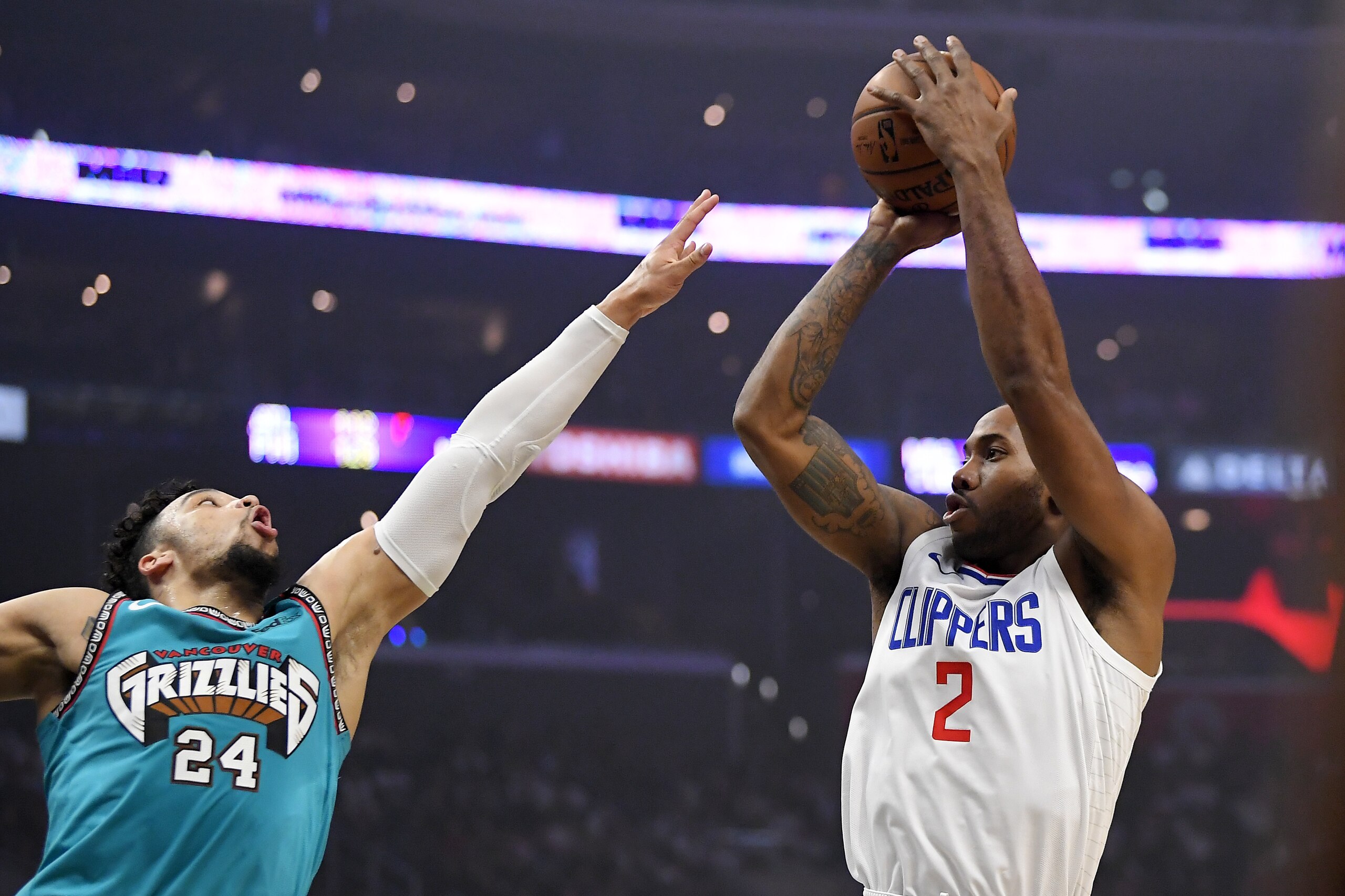 Los Angeles Clippers forward Kawhi Leonard, right, shoots as Memphis Grizzlies guard Dillon Brooks defends during the first half of an NBA basketball game Monday, Feb. 24, 2020, in Los Angeles. (AP Photo/Mark J. Terrill)