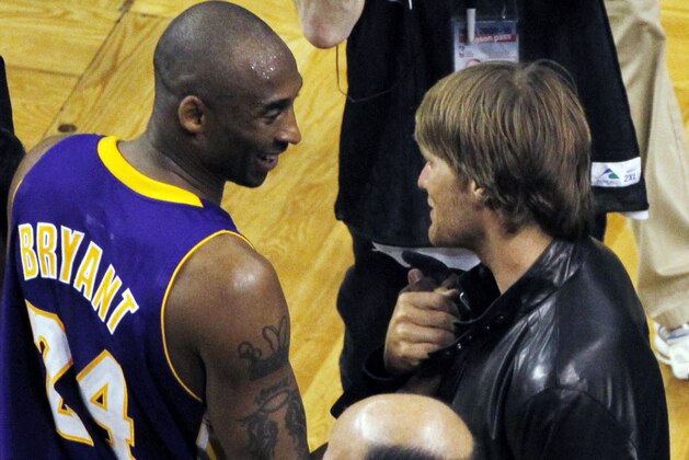 Los Angeles Lakers guard Kobe Bryant, left, talks to New England Patriots quarterback Tom Brady, right, after Game 3 of the NBA basketball finals between the Boston Celtics and the Lakers on Tuesday, June 8, 2010, in Boston. The Lakers won 91-84. (AP Photo/Charles Krupa)