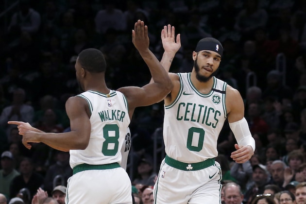 Boston Celtics forward Jayson Tatum (0) and Kemba Walker celebrate a basket during the first half of an NBA basketball game against the Atlanta Hawks, Friday, Feb. 7, 2020, in Boston. (AP Photo/Mary Schwalm)