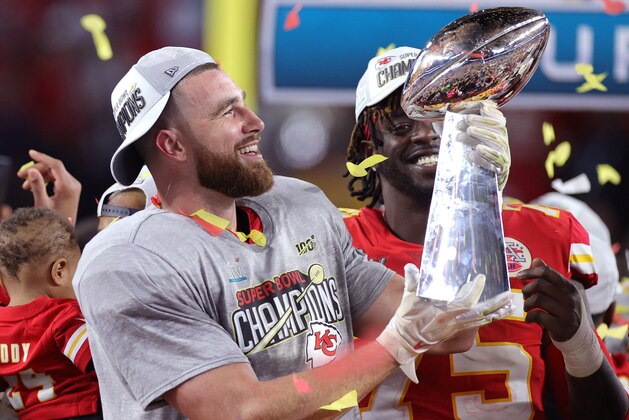 MIAMI, FLORIDA - FEBRUARY 02: Travis Kelce #87 of the Kansas City Chiefs raises the Vince Lombardi Trophy after defeating the San Francisco 49ers 31-20 in Super Bowl LIV at Hard Rock Stadium on February 02, 2020 in Miami, Florida. (Photo by Rob Carr/Getty Images)