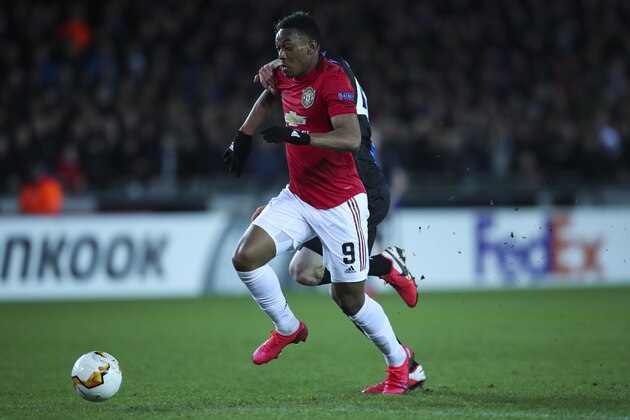 Manchester United's Anthony Martial, front, vies for the ball with Brugge's Brandon Mechele to score his side first goal during an Europa League round of 32 first leg soccer match between Brugge and Manchester United at the Jan Breydel stadium in Bruges, Belgium, Thursday, Feb. 20, 2020. Martial scored once and the match ended in a 1-1 draw. (AP Photo/Francisco Seco)