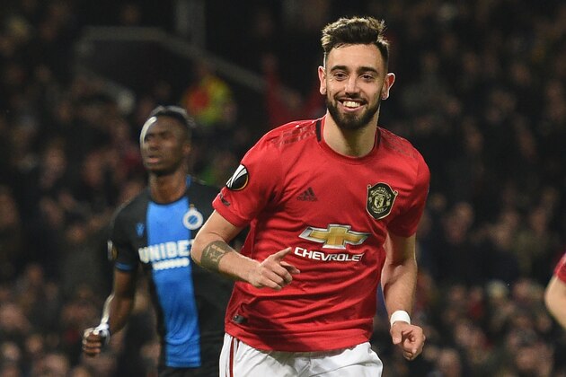 Manchester United's Portuguese midfielder Bruno Fernandes celebrates scoring his team's first goal during the UEFA Europa League round of 32 second leg football match between Manchester United and Club Brugge at Old Trafford in Manchester, north west England, on February 27, 2020. (Photo by Oli SCARFF / AFP) (Photo by OLI SCARFF/AFP via Getty Images)
