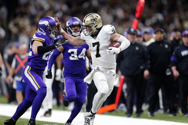 New Orleans Saints quarterback Taysom Hill (7) fends off Minnesota Vikings free safety Harrison Smith (22) on a long carry in the second half of an NFL wild-card playoff football game, Sunday, Jan. 5, 2020, in New Orleans. (AP Photo/Brett Duke)