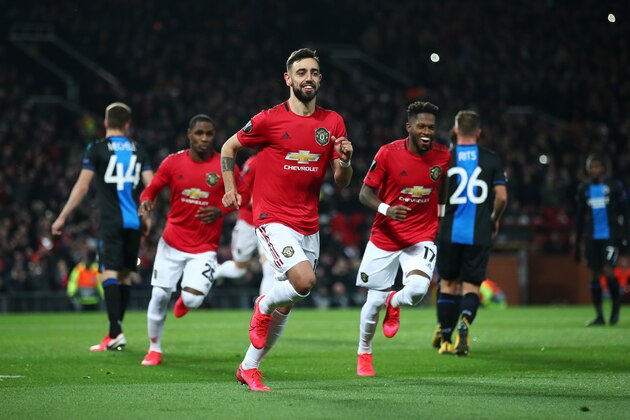 MANCHESTER, ENGLAND - FEBRUARY 27: Bruno Fernandes of Manchester United celebrates with teammates Odion Ighalo and Fred of Manchester United after scoring his team's first goal from the penalty spot during the UEFA Europa League round of 32 second leg match between Manchester United and Club Brugge at Old Trafford on February 27, 2020 in Manchester, United Kingdom. (Photo by Clive Brunskill/Getty Images)