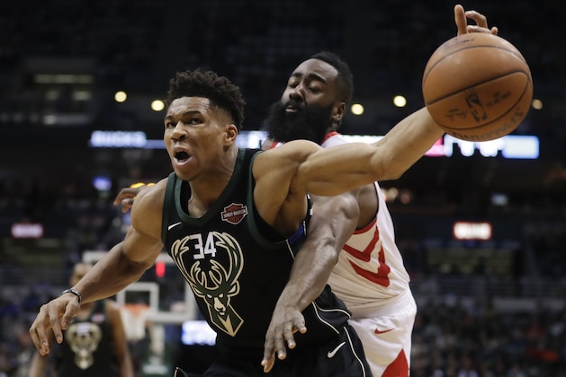 Milwaukee Bucks' Giannis Antetokounmpo is fouled by Houston Rockets' James Harden during the second half of an NBA basketball game Wednesday, March 7, 2018, in Milwaukee. (AP Photo/Morry Gash)