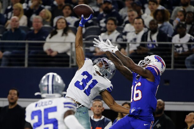 Dallas Cowboys safety Xavier Woods (25) looks on as cornerback Byron Jones (31) breaks up a pass intended or Buffalo Bills wide receiver Robert Foster (16) in the first half of an NFL football game in Arlington, Texas, Thursday, Nov. 28, 2019. (AP Photo/Michael Ainsworth)