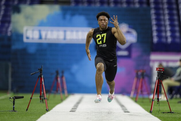 Wisconsin running back Jonathan Taylor runs the 40-yard dash at the NFL football scouting combine in Indianapolis, Friday, Feb. 28, 2020. (AP Photo/Michael Conroy)