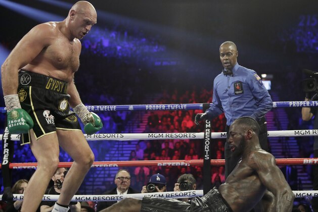 Tyson Fury, of England, knocks down Deontay Wilder during a WBC heavyweight championship boxing match Saturday, Feb. 22, 2020, in Las Vegas. (AP Photo/Isaac Brekken)