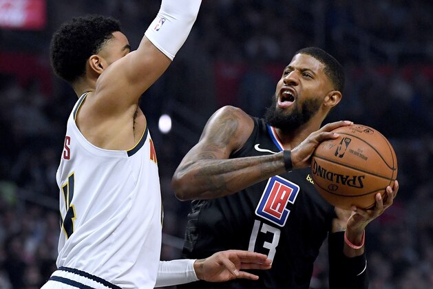 LOS ANGELES, CALIFORNIA - FEBRUARY 28:  Paul George #13 of the LA Clippers reacts as he attempts a shot in front of Gary Harris #14 of the Denver Nuggets during the first half at Staples Center on February 28, 2020 in Los Angeles, California. (Photo by Harry How/Getty Images)