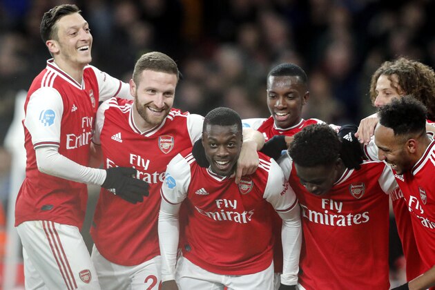 Arsenal's Nicolas Pepe, center, celebrates after scoring his side's second goal during the English Premier League soccer match between Arsenal and Newcastle at the Emirates Stadium in London, Sunday, Feb. 16, 2020.(AP Photo/Frank Augstein)