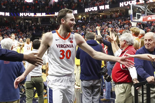 Virginia forward Jay Huff (30) celebrates with fans after defeating Duke in an NCAA college basketball game Saturday, Feb. 29, 2020, in Charlottesville, Va. (AP Photo/Andrew Shurtleff)