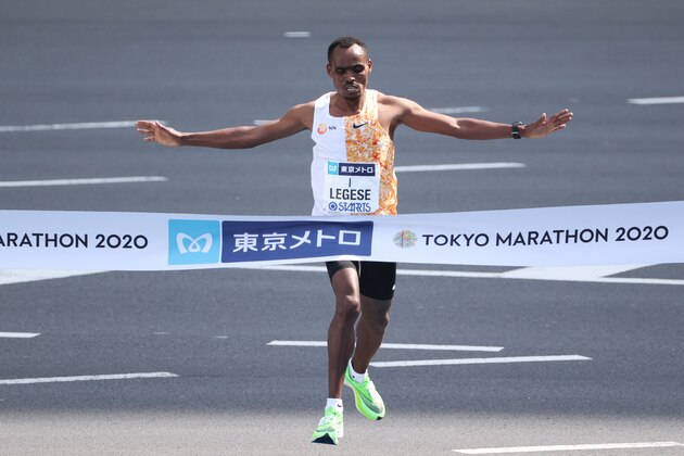 TOKYO, JAPAN - MARCH 01: Birhanu Legese of Ethiopia #1 celebrates as he crosses the finish line to win the men’s competition during the Tokyo Marathon on March 01, 2020 in Tokyo, Japan. The organizer had restricted the entry to elite runners only as the marathon acts as the final domestic qualifying for the Tokyo Olympic Games men's marathon due to the COVID-19 new coronavirus outbreak. (Photo by Takashi Aoyama/Getty Images)