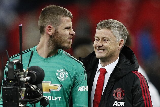 Manchester United's Spanish goalkeeper David de Gea (L) jokes with Manchester United's  Norwegian caretaker manager Ole Gunnar Solskjaer following the English Premier League football match between Tottenham Hotspur and Manchester United at Wembley Stadium in London, on January 13, 2019. - Manchester United won 1-0. (Photo by Adrian DENNIS / AFP) / RESTRICTED TO EDITORIAL USE. No use with unauthorized audio, video, data, fixture lists, club/league logos or 'live' services. Online in-match use limited to 120 images. An additional 40 images may be used in extra time. No video emulation. Social media in-match use limited to 120 images. An additional 40 images may be used in extra time. No use in betting publications, games or single club/league/player publications. /         (Photo credit should read ADRIAN DENNIS/AFP via Getty Images)