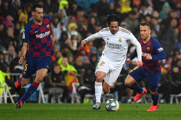 Barcelona's Spanish midfielder Sergio Busquets and Barcelona's Brazilian midfielder Arthur (R) challenge Real Madrid's Spanish midfielder Isco (C) during the Spanish League football match between Real Madrid and Barcelona at the Santiago Bernabeu stadium in Madrid on March 1, 2020. (Photo by GABRIEL BOUYS / AFP) (Photo by GABRIEL BOUYS/AFP via Getty Images)