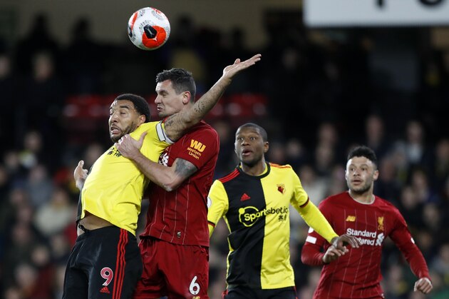 Watford's Troy Deeney, left, duels for the ball with Liverpool's Dejan Lovren during the English Premier League soccer match between Watford and Liverpool at Vicarage Road stadium, in Watford, England, Saturday, Feb. 29, 2020. (AP Photo/Alastair Grant)