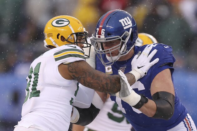 Green Bay Packers outside linebacker Preston Smith (91) and New York Giants offensive tackle Nate Solder (76) lock up during the first half of an NFL football game, Sunday, Dec. 1, 2019, in East Rutherford, N.J. The Green Bay Packers won 31-13. (AP Photo/Steve Luciano)