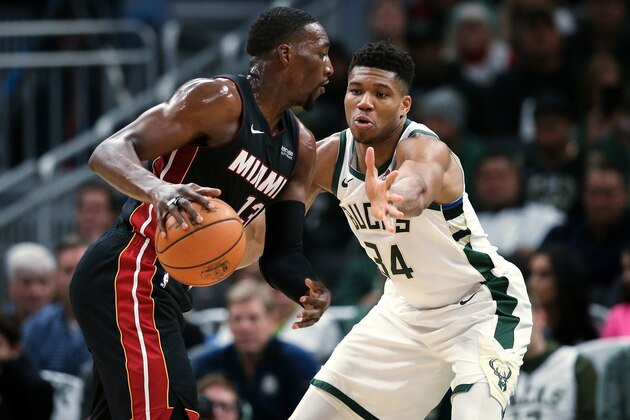 MILWAUKEE, WISCONSIN - OCTOBER 26:  Bam Adebayo #13 of the Miami Heat dribbles the ball while being guarded by Giannis Antetokounmpo #34 of the Milwaukee Bucks in the second quarter at the Fiserv Forum on October 26, 2019 in Milwaukee, Wisconsin. NOTE TO USER: User expressly acknowledges and agrees that, by downloading and/or using this photograph, user is consenting to the terms and conditions of the Getty Images License Agreement. (Photo by Dylan Buell/Getty Images)