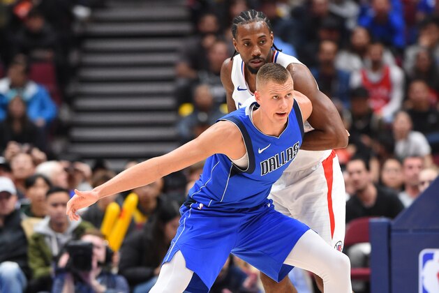LOS ANGELES, CA - OCTOBER 17: Kristaps Porzingis #6 of the Dallas Mavericks and Kawhi Leonard #2 of the LA Clippers fight for position during a pre-season game on October 17, 2019 at Rogers Arena in Vancouver, Canada. NOTE TO USER: User expressly acknowledges and agrees that, by downloading and/or using this Photograph, user is consenting to the terms and conditions of the Getty Images License Agreement. Mandatory Copyright Notice: Copyright 2019 NBAE (Photo by Andrew D. Bernstein/NBAE via Getty Images)