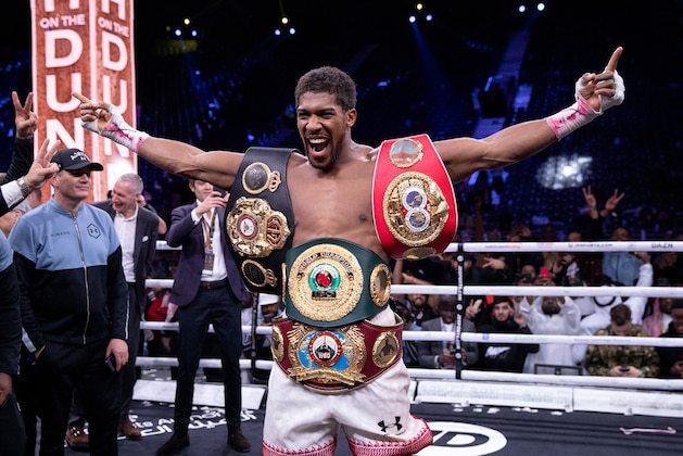 DIRIYAH, SAUDI ARABIA - DECEMBER 07:  Anthony Joshua poses for a photo with the IBF, WBA, WBO & IBO World Heavyweight Title belts after the IBF, WBA, WBO & IBO World Heavyweight Title Fight between Andy Ruiz Jr and Anthony Joshua during the Matchroom Boxing 'Clash on the Dunes' show at the Diriyah Season on December 07, 2019 in Diriyah, Saudi Arabia (Photo by Richard Heathcote/Getty Images)