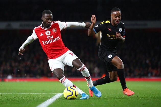 LONDON, ENGLAND - DECEMBER 15: Nicolas Pepe of Arsenal is challenged by Raheem Sterling of Manchester City during the Premier League match between Arsenal FC and Manchester City at Emirates Stadium on December 15, 2019 in London, United Kingdom. (Photo by Julian Finney/Getty Images)