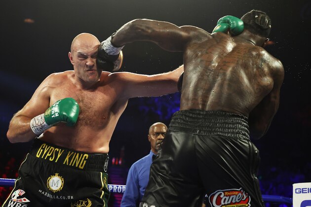 LAS VEGAS, NEVADA - FEBRUARY 22:  Deontay Wilder punches Tyson Fury during their Heavyweight bout for Wilder's WBC and Fury's lineal heavyweight title on February 22, 2020 at MGM Grand Garden Arena in Las Vegas, Nevada. (Photo by Al Bello/Getty Images)