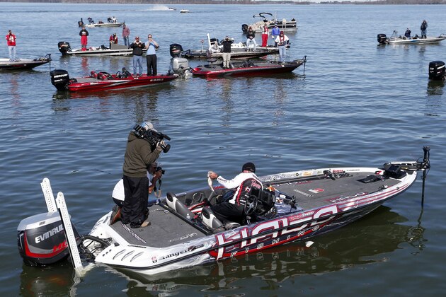 Randall Tharp, Port Saint Joe, Fla., holds up a bass for spectators following him on the second day of the Bassmaster Classic, Saturday, Feb. 22, 2014, in Guntersville, Ala. Tharp was bumped from first to second by 1 ounce by Edwin Evers, Talala, Okla. The field will be cut to the top 25 anglers for the final day of competition. (AP Photo/Hal Yeager) Randall Tharp, Port Saint Joe, Fla., holds up a bass for spectators following him on the second day of the Bassmaster Classic, Saturday, Feb. 22, 2014, in Guntersville, Ala. Tharp was bumped from first to second by 1 ounce by Edwin Evers, Talala, Okla. The field will be cut to the top 25 anglers for the final day of competition. (AP Photo/Hal Yeager)