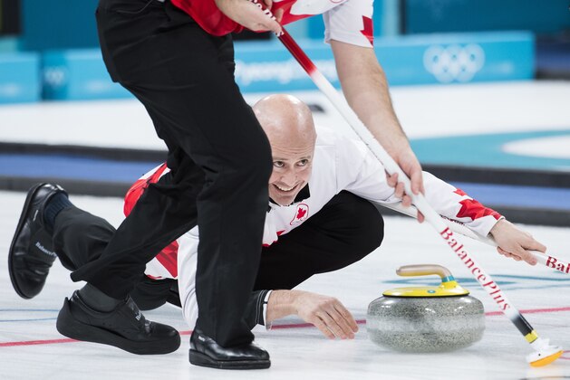Kevin Koe of Canada throws his rock during men's bronze medal curling finals against Switzerland at the 2018 Olympic Winter Games in Gangneung, South Korea on Friday, February 23, 2018. (Nathan Denette/The Canadian Press via AP)