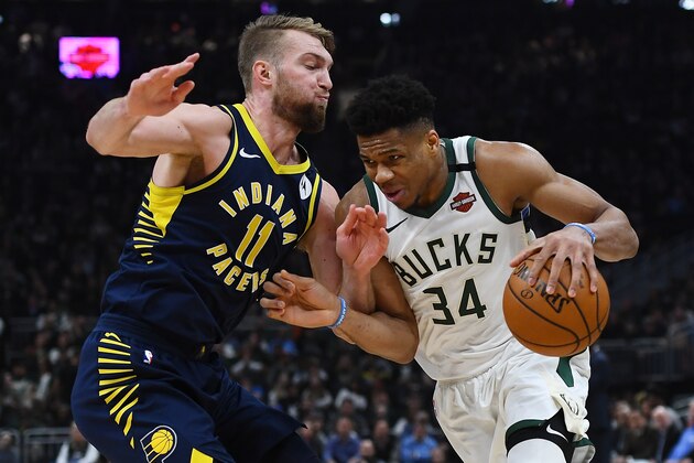 MILWAUKEE, WISCONSIN - MARCH 04:  Giannis Antetokounmpo #34 of the Milwaukee Bucks is defended by Domantas Sabonis #11 of the Indiana Pacers during the first half of a game at Fiserv Forum on March 04, 2020 in Milwaukee, Wisconsin.  NOTE TO USER: User expressly acknowledges and agrees that, by downloading and or using this photograph, User is consenting to the terms and conditions of the Getty Images License Agreement. (Photo by Stacy Revere/Getty Images)