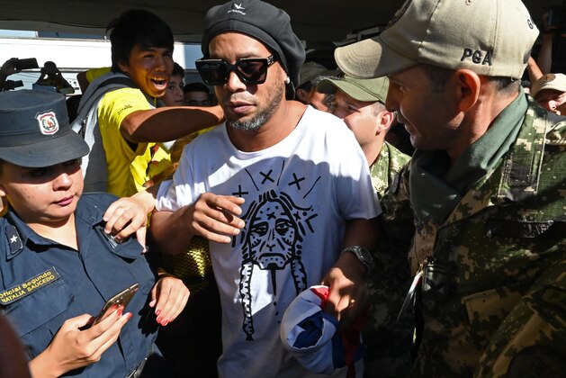 Brazilian ex-football star Ronaldinho Gaucho arrives at Silvio Pettirossi International Airport in Luque, near Asuncion, on March 4, 2020. - Ronaldinho arrived in Paraguay to present his latest book