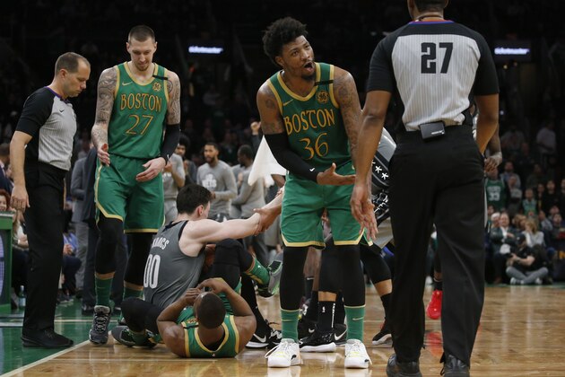 Boston Celtics guard Marcus Smart (36) complains about a jump-ball call to referee Mitchell Ervin (27) during the second half of the team's NBA basketball game against the Brooklyn Nets, Tuesday, March 3, 2020, in Boston. (AP Photo/Mary Schwalm)