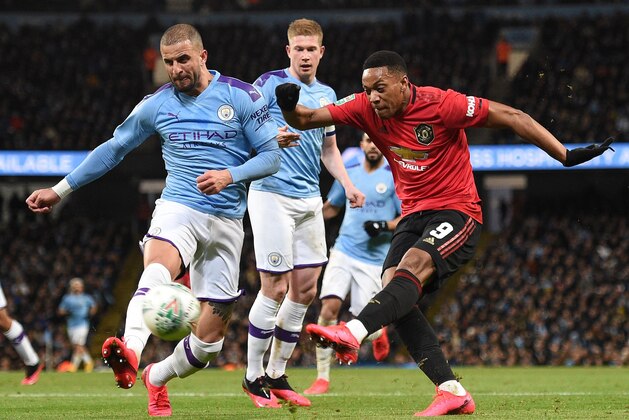 Manchester United's French striker Anthony Martial (R) shoots but fails to score during the English League Cup semi-final second leg football match between Manchester City and Manchester United at the Etihad Stadium in Manchester, north west England, on January 29, 2020. (Photo by Oli SCARFF / AFP) / RESTRICTED TO EDITORIAL USE. No use with unauthorized audio, video, data, fixture lists, club/league logos or 'live' services. Online in-match use limited to 120 images. An additional 40 images may be used in extra time. No video emulation. Social media in-match use limited to 120 images. An additional 40 images may be used in extra time. No use in betting publications, games or single club/league/player publications. /  (Photo by OLI SCARFF/AFP via Getty Images)