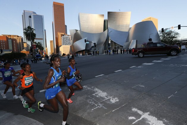 Los Angeles Marathon Elite Women runners race past the Walt Disney Concert Hall in Los Angeles Sunday, March 18, 2018. (AP Photo/Damian Dovarganes)