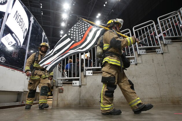 Firefighters walk the arena during the Tower Challenge remembering the 9/11 terrorist attack victims at Gila River Arena Wednesday, Sept. 11, 2019, in Glendale, Ariz. Participants recreated the 110 flights of stairs (2071 steps) climbed by New York City Firefighters and other first responders during the attacks on the World Trade Center. (AP Photo/Ross D. Franklin)