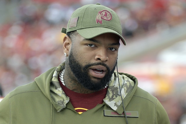 FILE - In this Nov. 11, 2018, file photo, Washington Redskins offensive tackle Trent Williams stands on the sideline during the second half of an NFL football game against the Tampa Bay Buccaneers in Tampa, Fla. A person with knowledge of the situation says Williams has reported to the Redskins, ending his holdout. The person spoke to The Associated Press on condition of anonymity on Tuesday, Oct. 29, 2019, because the team had not announced Williams’ return. He can be kept off the 53-man roster for up to three weeks after reporting.(AP Photo/Phelan M. Ebenhack, File)