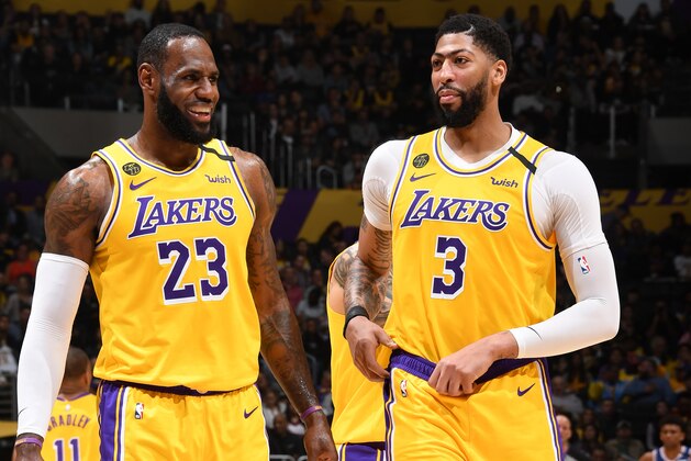 LOS ANGELES, CA - MARCH 3: LeBron James #23, and Anthony Davis #3 of the Los Angeles Lakers smile during the game against the Philadelphia 76ers on March 03, 2020 at STAPLES Center in Los Angeles, California. NOTE TO USER: User expressly acknowledges and agrees that, by downloading and/or using this Photograph, user is consenting to the terms and conditions of the Getty Images License Agreement. Mandatory Copyright Notice: Copyright 2020 NBAE (Photo by Andrew D. Bernstein/NBAE via Getty Images)