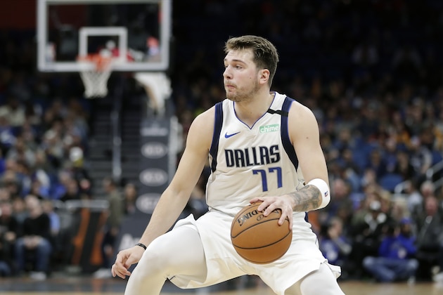 Dallas Mavericks guard Luka Doncic moves the ball during the first half of an NBA basketball game, Friday, Feb. 21, 2020, in Orlando, Fla. (AP Photo/John Raoux)