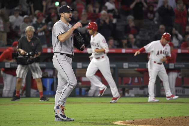 Houston Astros starting pitcher Justin Verlander, second from left, walks back to the mound after giving up a two-run home run to Los Angeles Angels' Andrelton Simmons, second from right, during the fourth inning of a baseball game Saturday, Sept. 28, 2019, in Anaheim, Calif. (AP Photo/Mark J. Terrill)