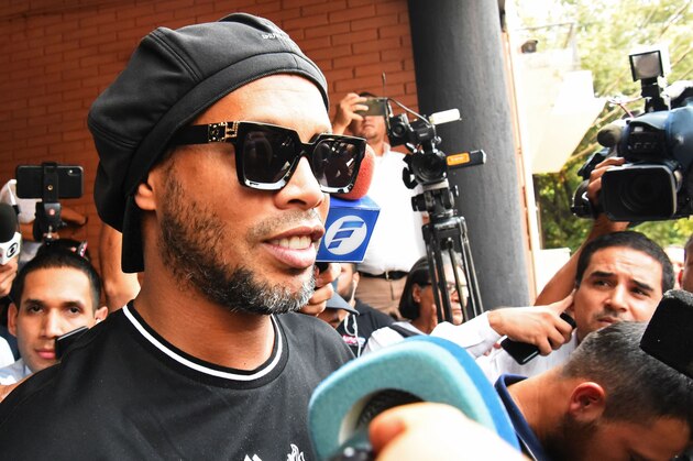 TOPSHOT - Brazilian retired football player Ronaldinho leaves Asuncion's Prosecution after declaring about his irregular entry to the country, in Asuncion, Paraguay, on March 5, 2020. - Former Brazilian football star Ronaldinho and his brother have been detained in Paraguay after allegedly using fake passports to enter the South American country, authorities said Wednesday. (Photo by NORBERTO DUARTE / AFP) (Photo by NORBERTO DUARTE/AFP via Getty Images)