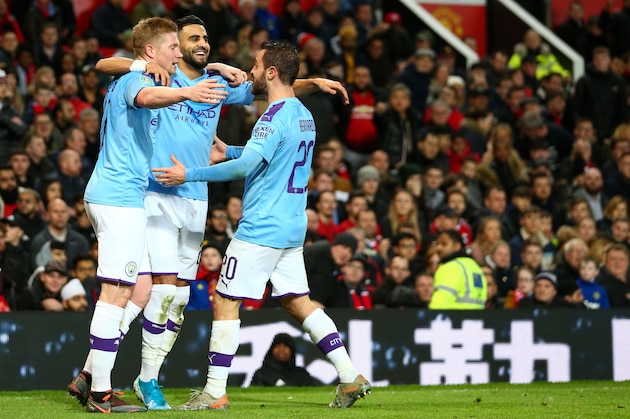 MANCHESTER, ENGLAND - JANUARY 07: Riyad Mahrez of Manchester City celebrates after scoring a goal to make it 0-2 with Kevin De Bruyne and Bernardo Silva during the Carabao Cup Semi Final match between Manchester United and Manchester City at Old Trafford on January 7, 2020 in Manchester, England. (Photo by Robbie Jay Barratt - AMA/Getty Images)